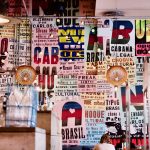 Interior showing printed Portuguese words on posters and various types of lighting as seen at Cabana Brazilian barbecue restaurant at Westfield Stratford branch East London.